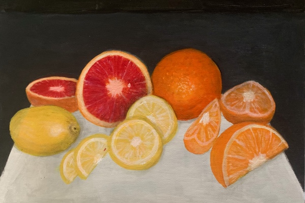 Slices of citrus fruits on a white table.