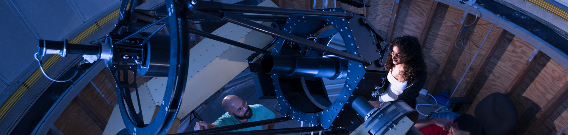 Student looking out of a telescope