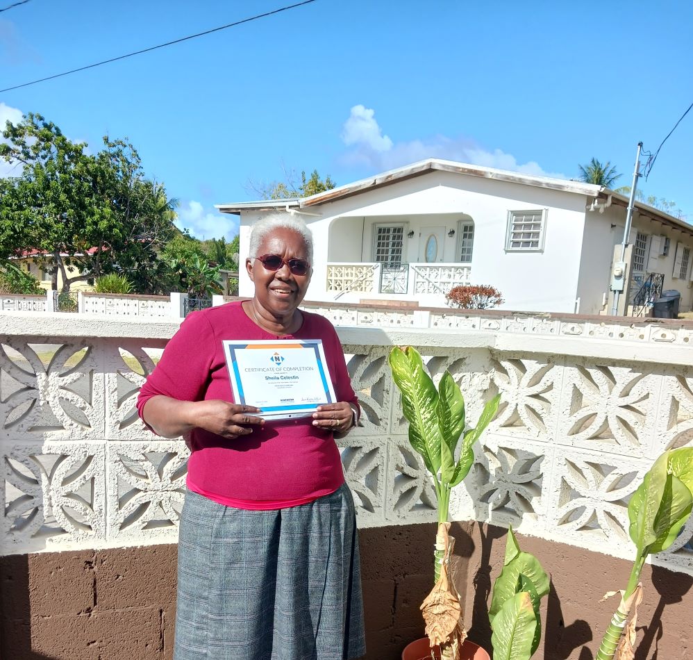 A community participant displays her certificate