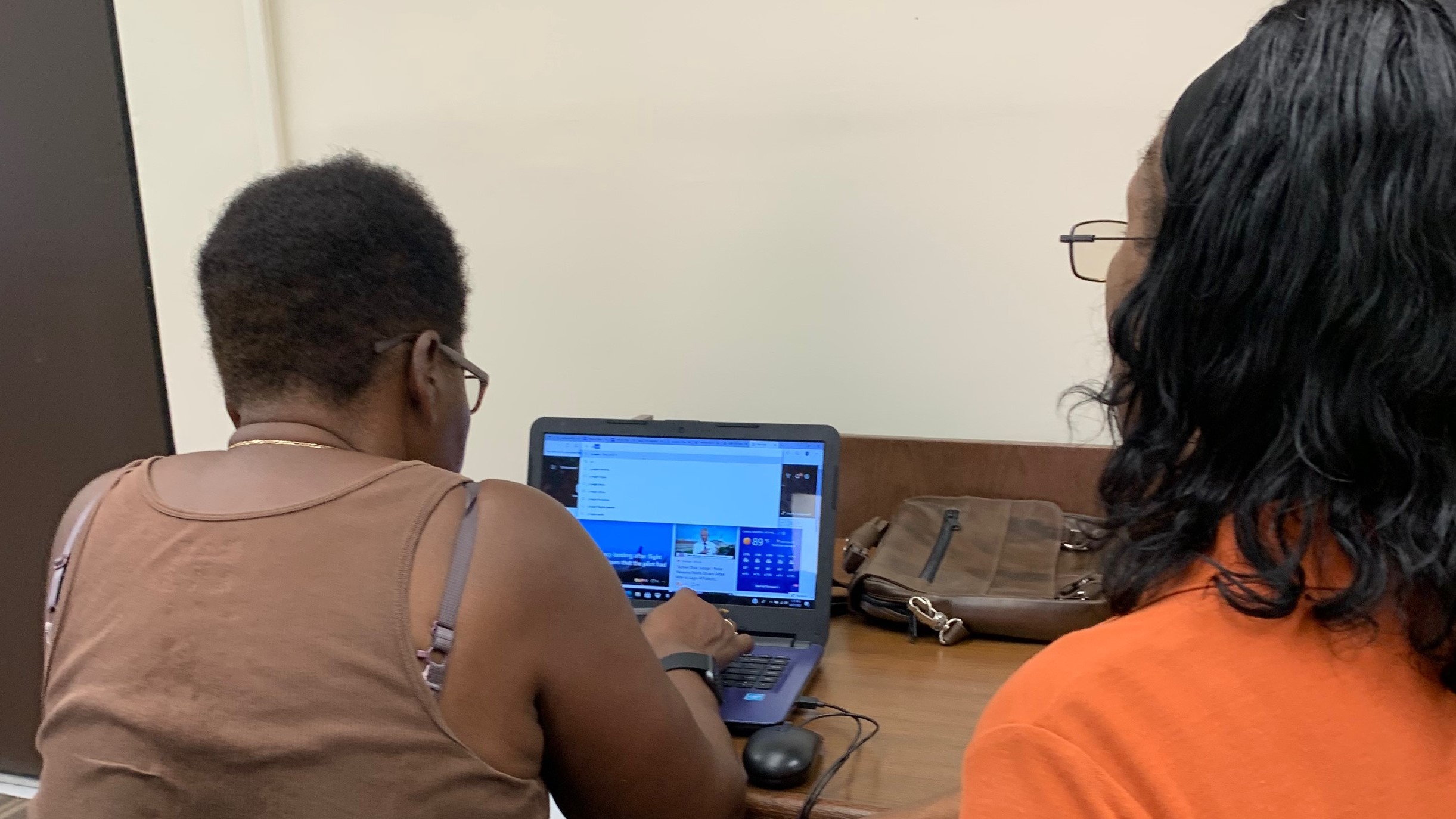 Librarian, Janice Simon, works with a community member.