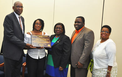 UVI President Dr. David Hall presents the President’s Appreciation Award to the Voices of Inspiration Community Choir at the June 2013 Board of Trustees meeting.