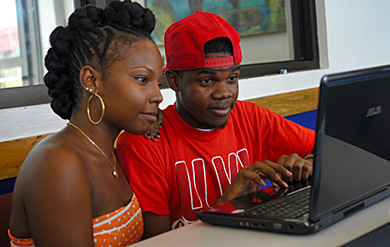 two students share a laptop computer