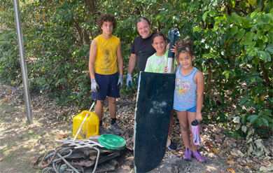 Students picking up trash by mangroves